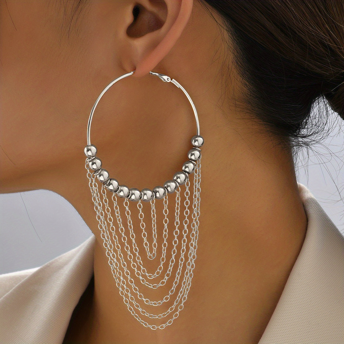 A Pair of Golden Circular Tassel Hoop Earrings