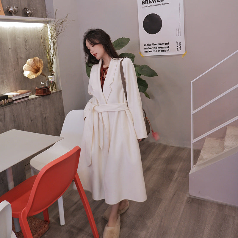 A minimalist mid-length woolen coat