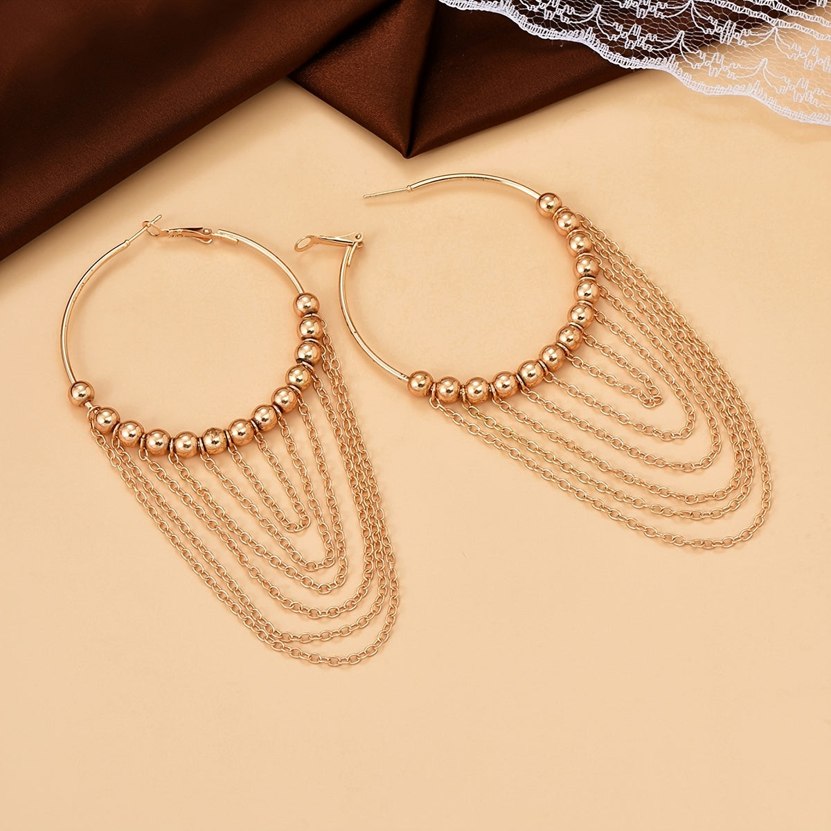 A Pair of Golden Circular Tassel Hoop Earrings