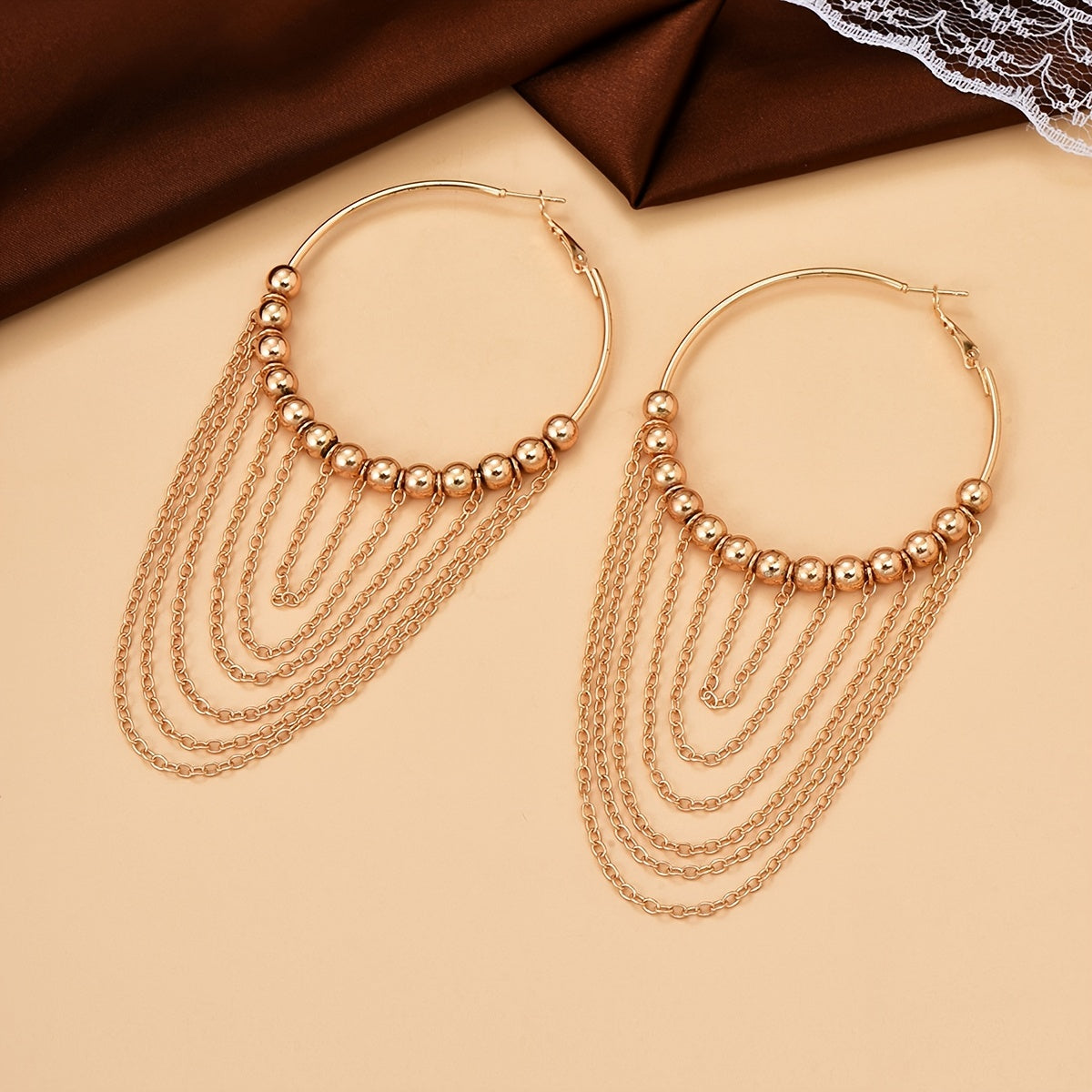 A Pair of Golden Circular Tassel Hoop Earrings